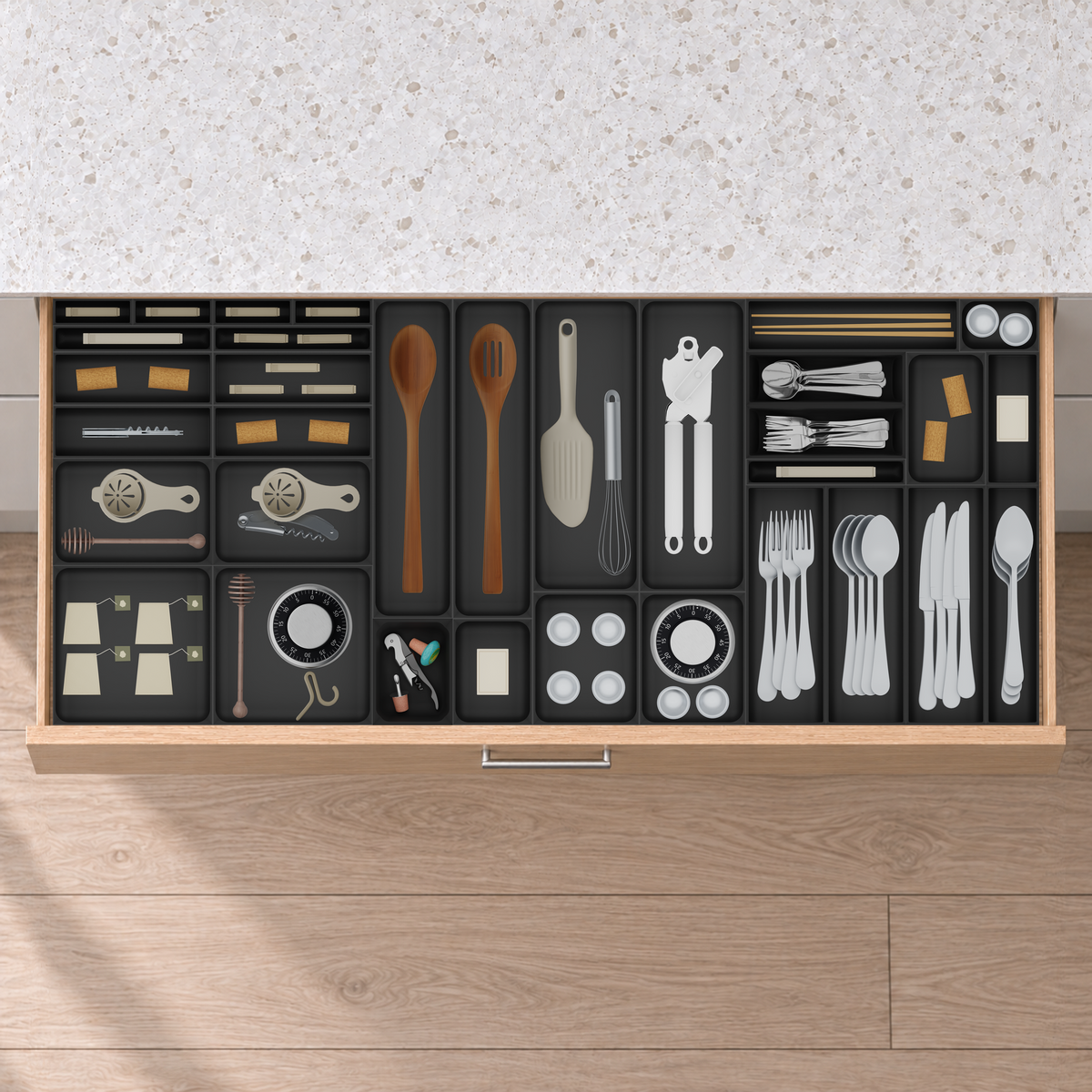 Extra-Wide Cutlery & Kitchen Tools Drawer Organiser Set in Charcoal Black, fitted in an oak drawer under neutral white light. Nominal layout 1091.5 × 472 mm. Accessories shown are not included.