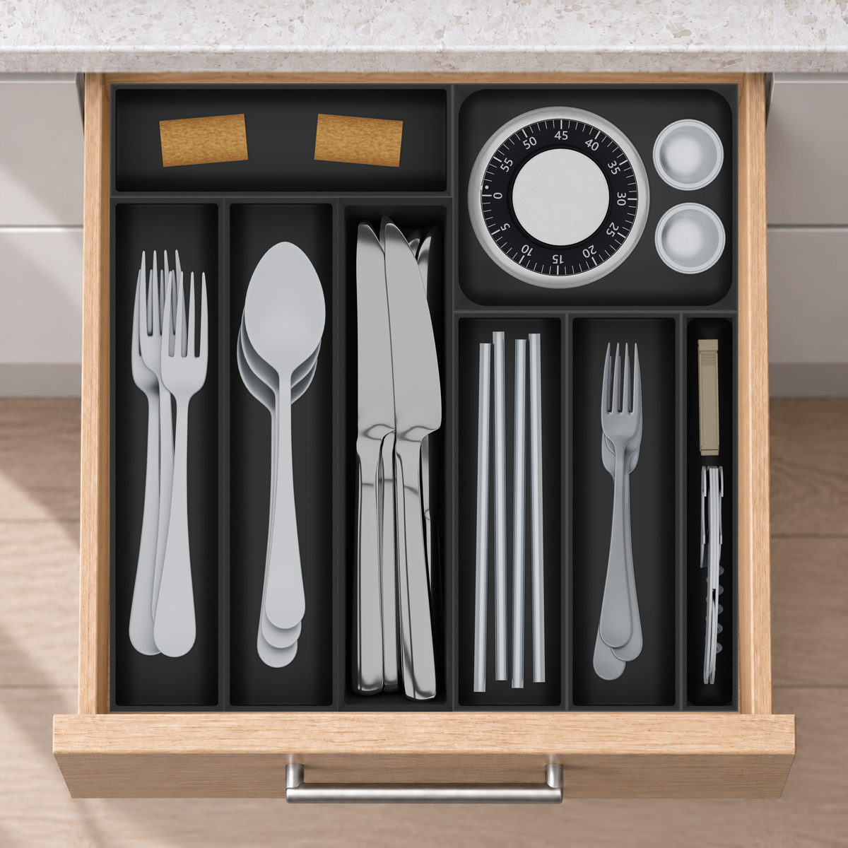 Square Kitchen Drawer Organiser Set in Charcoal Black, fitted in an oak drawer under neutral white light. Nominal layout 324.5 × 324.5 mm. Accessories shown are not included.