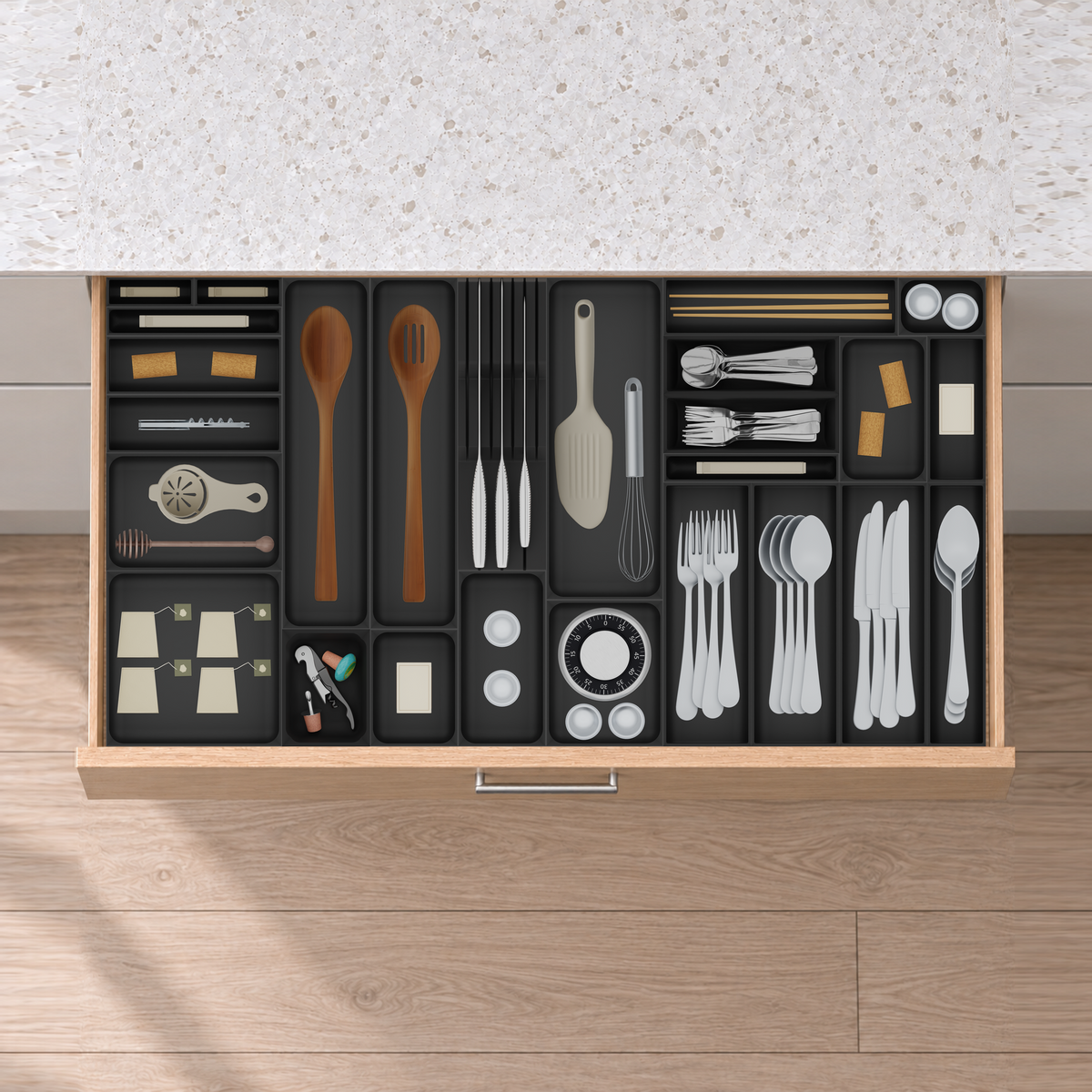 Wide Cutlery, Knives & Kitchen Tools Drawer Organiser Set in Charcoal Black, fitted in an oak drawer under neutral white light. Nominal layout 885 × 472 mm. Accessories shown are not included.