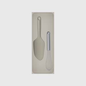 Long tray organiser – 11×4 (324.5 × 118 mm) in Muted White, shown with a whisk and bench scraper. Top view.