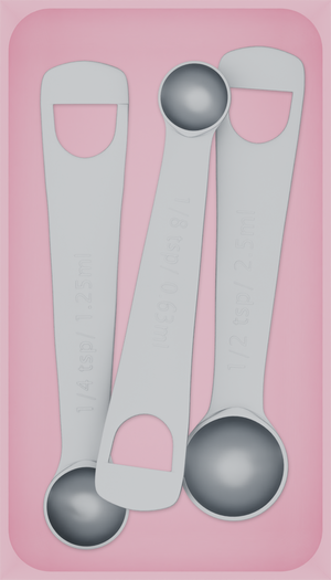 Medium tray organiser – 7×4 (206.5 × 118 mm) in Sakura Pink, shown with 3 measuring spoons. Top view.
